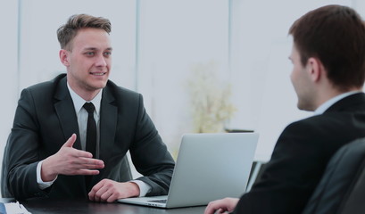 Fototapeta premium Manager sits behind the Desk and talks to the client