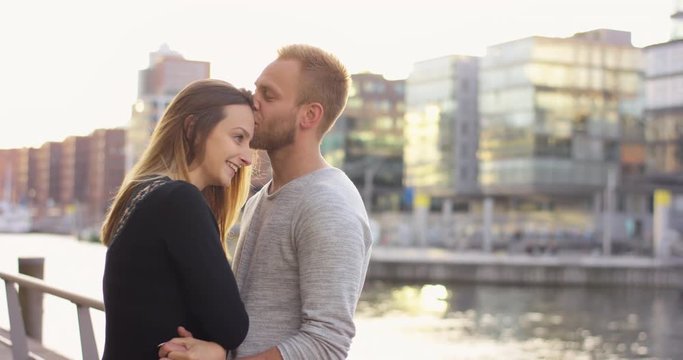 Attractive couple kissing and hugging in the city