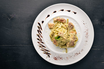 Pasta with white mushrooms and cream sauce. Tagliateli Italian cuisine. Free space for your text. Top view.