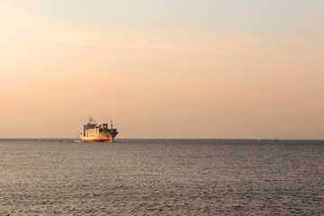 Not the big vessel with containers in the sunset sun.