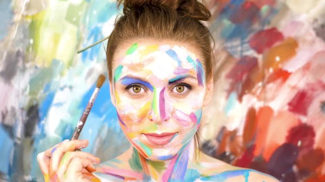 Artist Paints applying make up. Woman-Picture. Slow motion. 