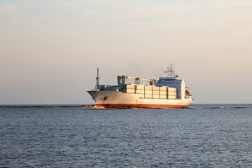 Not the big vessel with containers in the sunset sun.