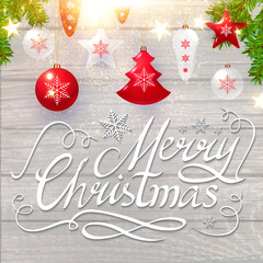Fototapeta na wymiar Merry Christmas Calligraphic Lettering on Elegant Soft Wood Textured Background with Golden Lights, Fir Tree Branches and Christmas Toys. Vector illustraion