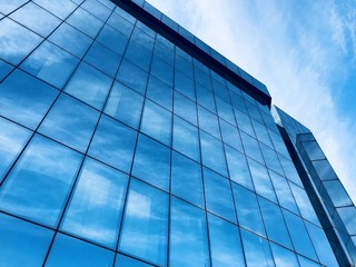 Fototapeta na wymiar Office Glass building with clouds reflection