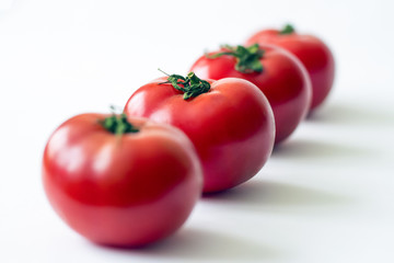 Bunch of fresh tomatoes with water drops. Isolated on white background. Top view.