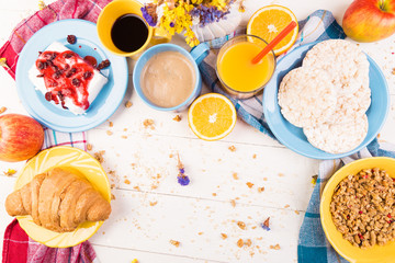 Fototapeta na wymiar Healthy Breakfast. Various Assortment Set. Orange Juice, Granola, Croissant, Coffee and Fruit.