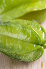 Closeup of carambola on wooden table.