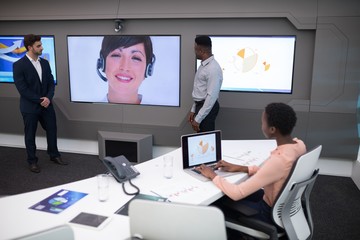 Male and female executives having video call