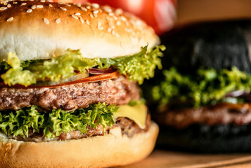 tasty burgers on wooden board