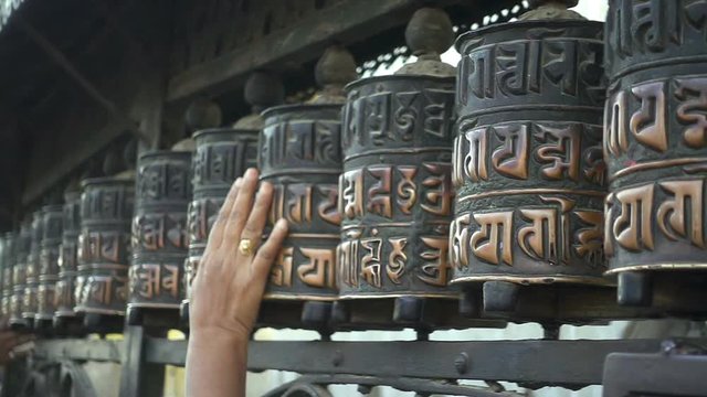 Spinning prayer wheels at the Swayambhunath Stupa, Kathmandu, Nepal.