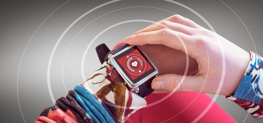 Composite image of woman using smart watch