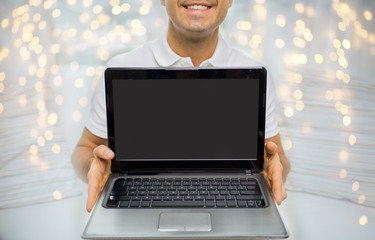 close up of happy man showing laptop