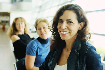 Indoor portrait of three beautiful 40 years old woman