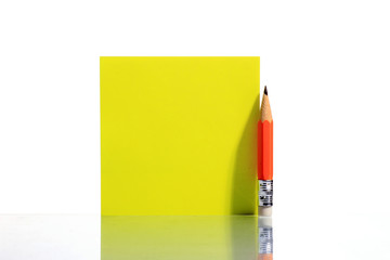 A pencil with white paper sticker. Blank note. Isolated on white.