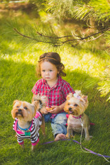 Baby girl and two yorkshire terrier