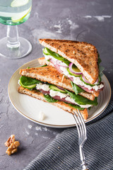 Sandwich with meat, fresh salad and vegetables.