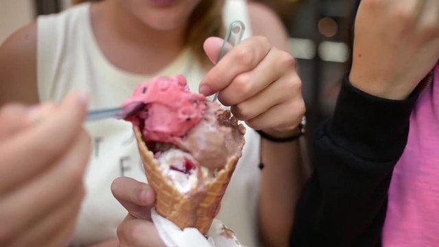 Three Girls eat fruity Plomber Ice cream Cone with Spoons