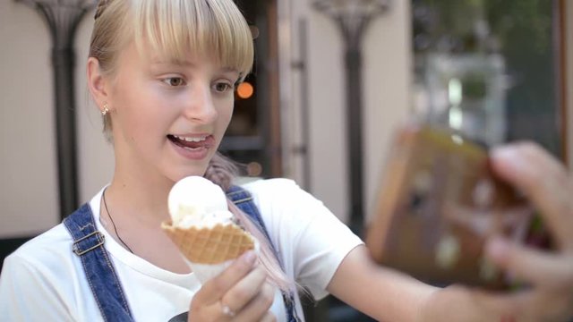 Girl with Ice Cream Cone make Selfie Photo with Smart Phone on the Day Street