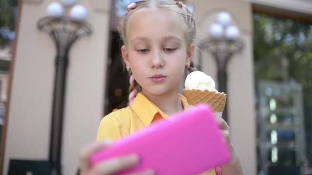 Girl with Ice Cream Cone make Selfie Photo with Smart Phone on the Day Street