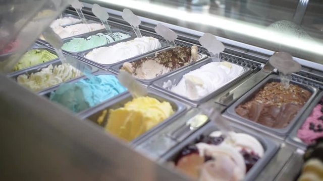 Close Up milk plomber Ice Cream Scooping Out Of Container to a Cone