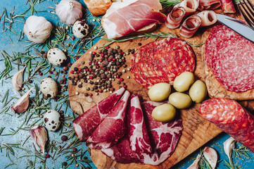 Antipasti and catering platter with different meat and cheese products. Various mixed meat and vegetable appetizers . Europe dinner food (German name is Brettljause).