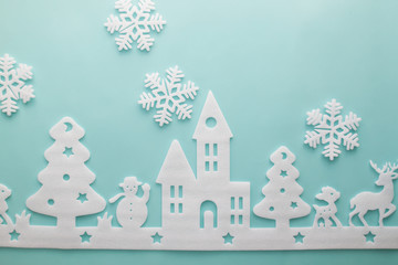Merry Christmas and Happy New Year. Foam cutter of City with snowflake, art and craft style on pastel color paper