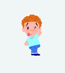 Blond boy in jeans sticks out his tongue in gesture of funny shyness.