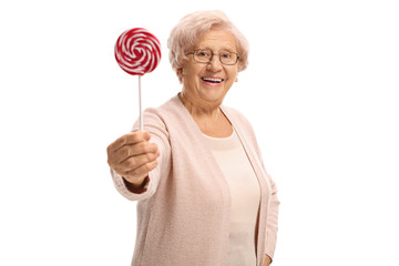 Elderly woman giving a lollipop