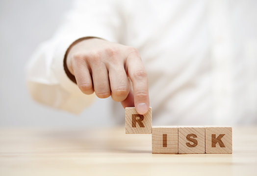 Hand and word Risk made with wooden building blocks