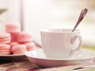White Cup of coffee in a cafe, macaroons