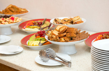 Dishes with fruits and sweets. The festive table at the Banquet