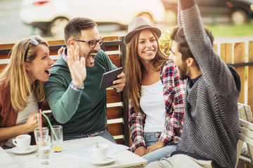 Group of five friends having a coffee together.