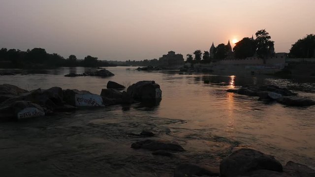 Cenotaphs at Orchha, Madhya Pradesh, famous travel destination in India. Holy Betwa river flowing at sunset.