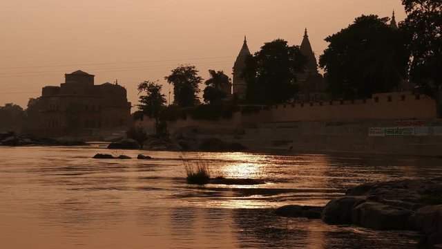 Cenotaphs at Orchha, Madhya Pradesh, famous travel destination in India. Holy Betwa river flowing at sunset.