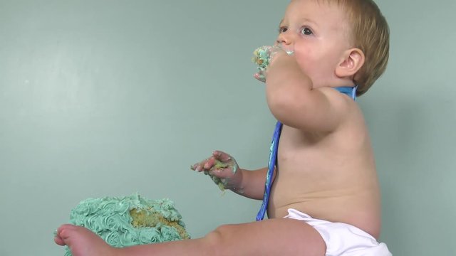 baby boy eating his first cake 4k