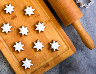Christmas gingerbread with decoration on a wooden board. Top view.
