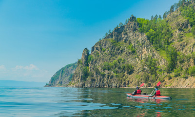 Fototapeta na wymiar Mеn kayaking on Lake Baikal. Landscape. Siberia.