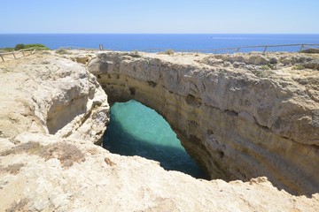 The beautiful natural arch Ãlgar de Albandeira in the algarvian coast, Algarve, Portugal