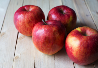 Fototapeta na wymiar Ripe red apples on wooden background.