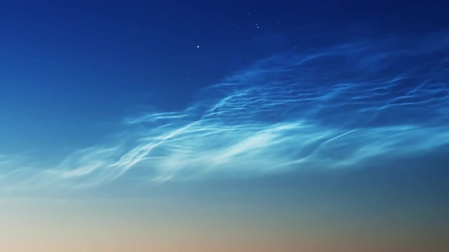 noctilucent clouds NLC with stars and filament gravity wave structure in summer morning twilight timelapse ZOOM IN