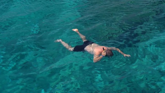 man swim in the red sea. Men diving in coral reef.