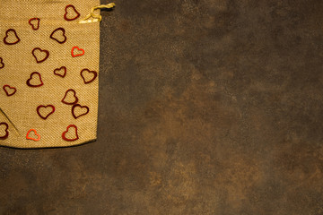 Fabric sack with  hearts on rustic background for Valentine's day