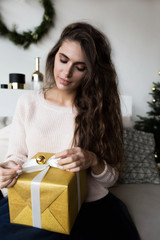 Stylish woman posing with Christmas present