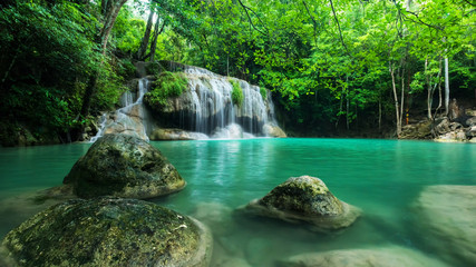 Fototapeta na wymiar Breathtaking green waterfall at deep forest, Erawan waterfall located Kanchanaburi Province, Thailand