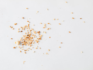 Scattered sesame seeds and crumbs isolated on white background