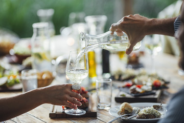 A Man Pouring Drink at Party