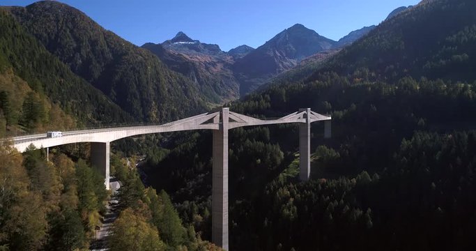 Alpine bridge, Cinema 4k aerial view over a big bridge, between mountains, on a sunny fall day, on simplon pass, in wallis, of the alps in Switzerland