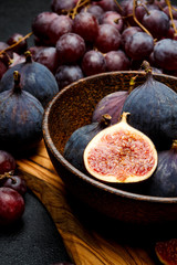 Ripe Grapes and Figs on dark concrete background