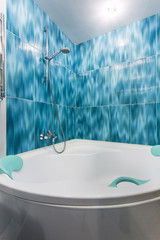 Interior of the modern bathroom in flat in light blue color style
