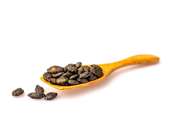 The zucchini  seeds in the  wooden spoon isolated on white background.